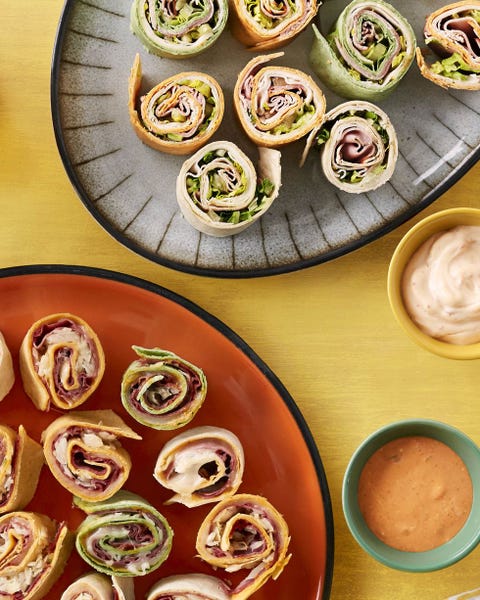 make ahead sandwich rolls on yellow background with two dips