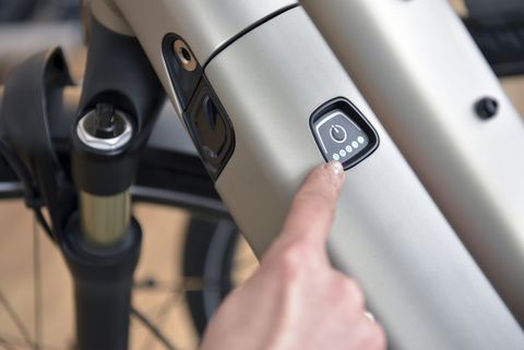 finger pointing on switch of an e bike