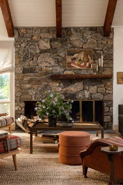 living room with stone fireplace surround