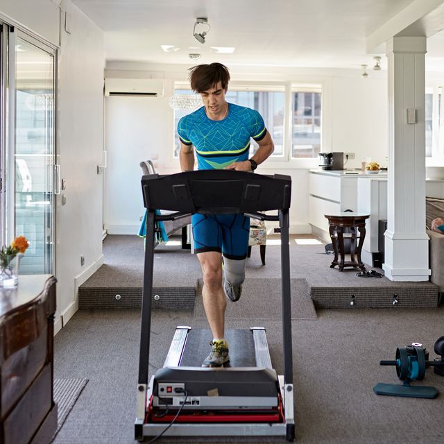 fit mid adult man working out at home on treadmill