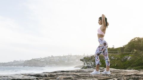Fit Woman Doing Yoga Routine Looking at Ocean