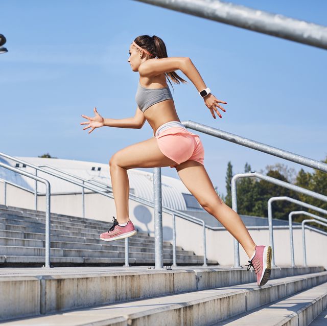 fit young woman running on stairs