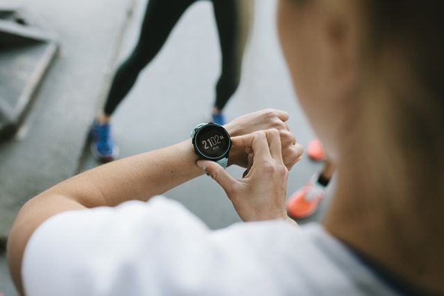 fitness enthusiast setting timer on her watch