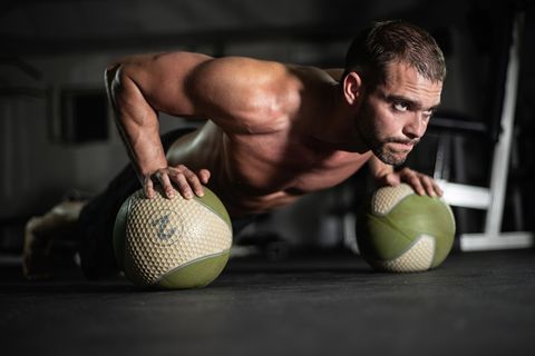 Fitness man does push-ups on the balls