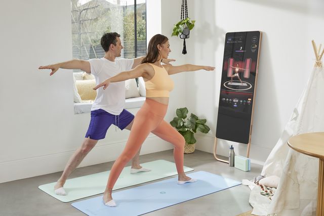 a couple using fiture interactive smart fitness mirror