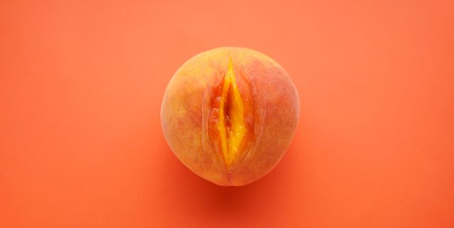 flat lay composition with juicy peach on a red background sex concept