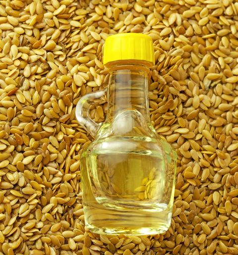 Flax seed oil and golden flax seeds, close-up