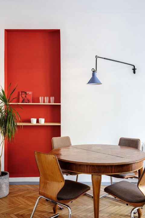 minimalist dining nook with red statement wall