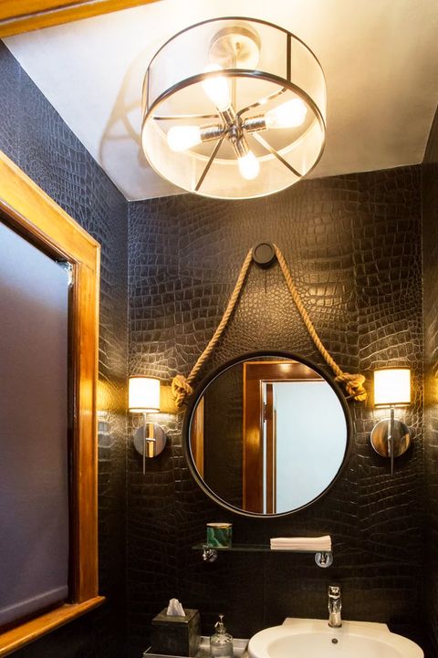 dark powder room with leather croc embossed wallpaper