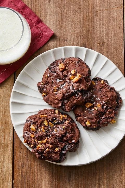 flourless chocolate walnut cookies on white plate and wooden table