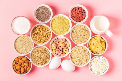 ingredients for healthy breakfast, shown on a pink background, including cereals, grains, dairy products, seeds, nuts to illustrate a story on how to keep your immune system healthy