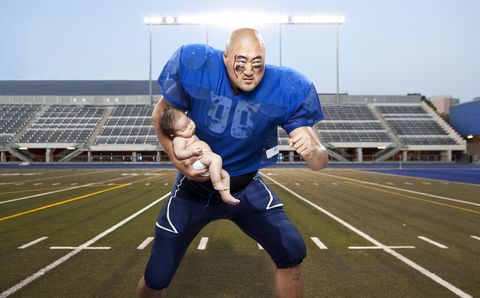 football player protecting baby