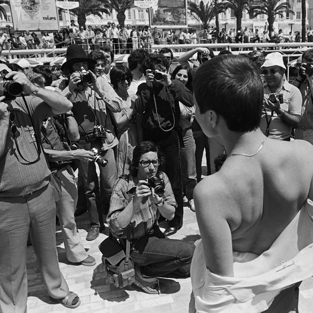 cannes, france   1980  an aspiring starlet causes a reaction among the street paparazzi gathered at the 1980 cannes, france, film festival photo by george rosegetty images