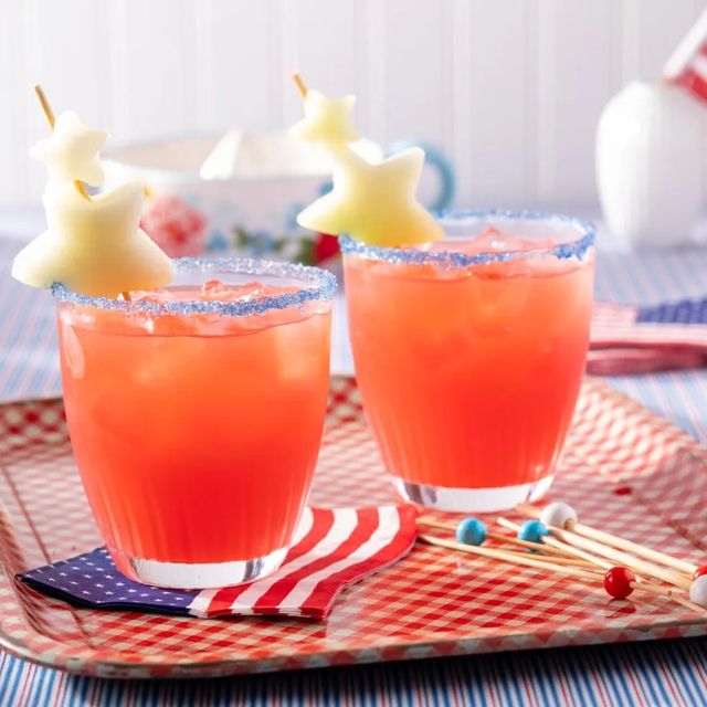 fourth of july drinks red cocktail with blue sugar rim and fruit stars on toothpick