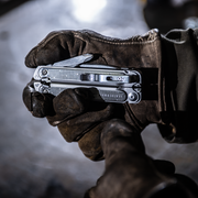 leatherman multi tool held in work worn leather glove