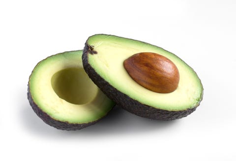 A fresh avocado cut in half A fresh avocado cut in half