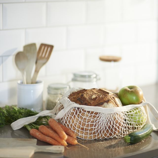 fresh bread organic vegetables and fruit on a plastic free zero waste kitchen worktop