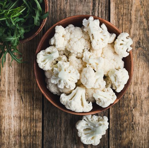fresh organic cauliflower cut into small pieces in a bowl vegetarian recipe or menu background with copy space