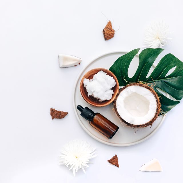 fresh organic healthy coconut butter with coconut pieces over white background