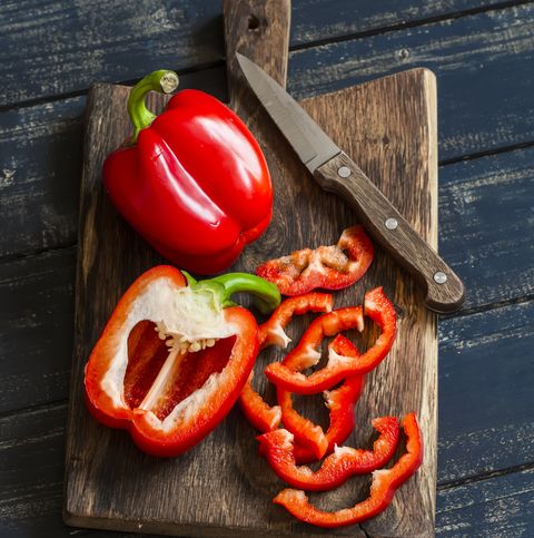Fresh red sweet pepper on a wooden rustic board