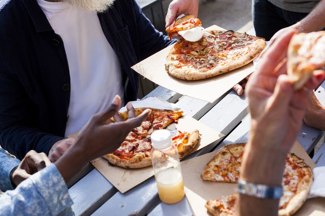 friends having pizza outdoors
