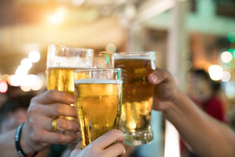 Friends toasting with glasses of light beer at the pub. Beautiful background of the Oktoberfest. A group of young people while relaxing at the bar. fine grain. Soft focus. Shallow DOF. Friends toasting with glasses of light beer at the pub. Beautiful background of the Oktoberfest. A group of young people while relaxing at the bar. fine grain. Soft focus. Shallow DOF.