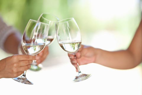 Friends toasting with wine outdoors