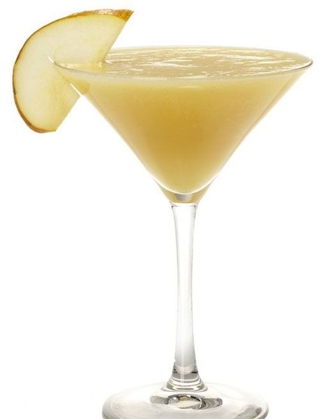 frozen pear slushie in a martini glass with a thin slice of pear as garnish