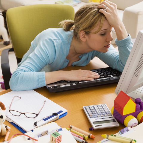 frustrated hispanic woman at desk surrounded by toys