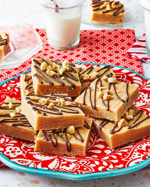 peanut butter fudge with chocolate drizzle on red plate