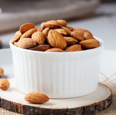 full bowl of almond nuts, rustic style