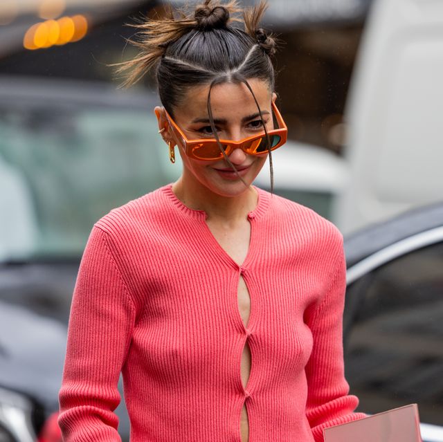 paris, france january 26 alexandra pereira wears wrapped red cardigan, brown pants with side pockets, micro bag, white bag, orange sunglasses outside fendi during paris fashion week haute couture spring summer day four on january 26, 2023 in paris, france photo by christian vieriggetty images
