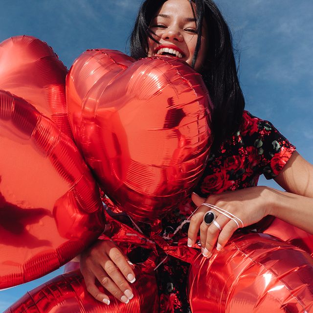 girl with red heart balloons