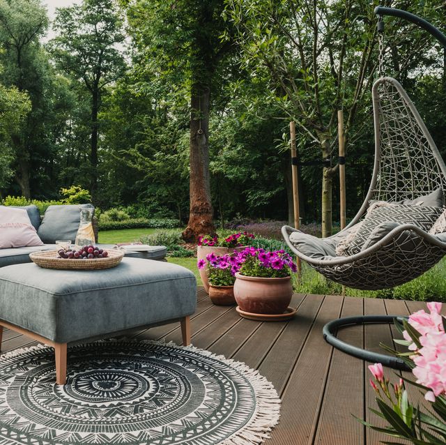 garden patio decorated with scandinavian wicker sofa and coffee table
