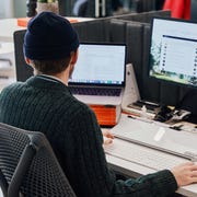 Gear Patrol man using laptop with feet up on sofa