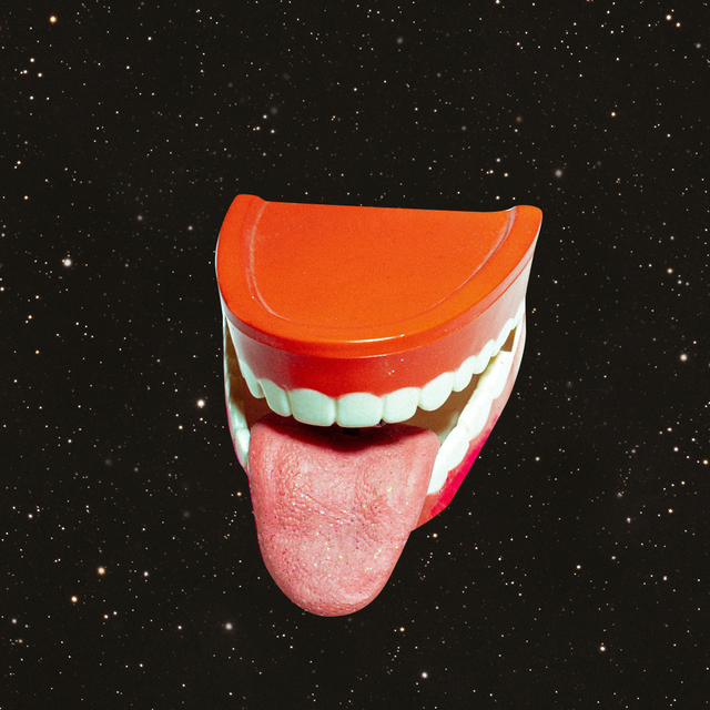a toy mouth complete with a tongue is in the middle of a starry sky