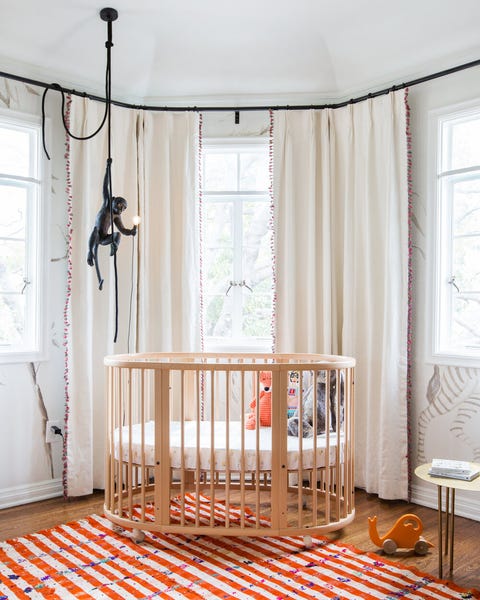 fun gender neutral nursery with orange rug