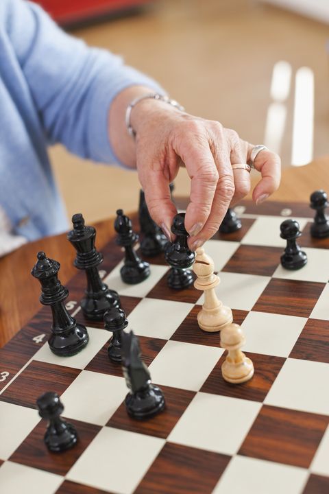 germany, leipzig, senior woman playing chess game
