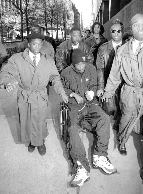ESQ060121_097 tupac shakur coming to court tupac shakur in a weel chair protected by 7 bodiguards december 01, 1994 photo by bolivar arellanonew york postphoto archives, llc via getty images