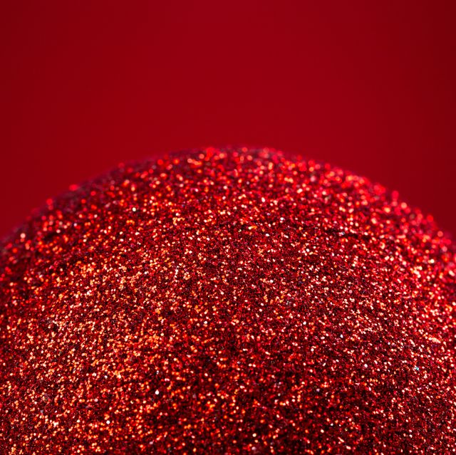red christmas ball on red background, close up