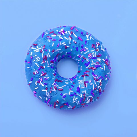 Blue donut in glaze on a blue background. Great fresh tasty cyan donut drizzled with glaze