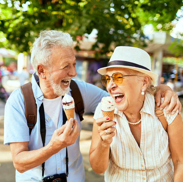 senior couple enjoying ice cream and laughing
