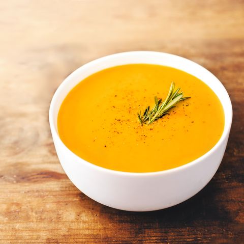 Squash Soup with Rosemary on rustic wooden table.  Autumn Pumpkin cream-soup with croutons. Top view. Copy space"n