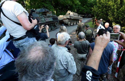 Search for WWII weapons in Heikendorf residents watch the transportation of a world war two era panther battle tank from a residential property in heikendorf, germany, 02 july 2015 since 01 july, police and armed forces are removing recently discovered military equipment from world war ii including the panther tank, weapons and a torpedo the armoured recovery vehicle is used for safe transportation of weapons photo carsten rehderdpa usage worldwide photo by carsten rehderpicture alliance via getty images