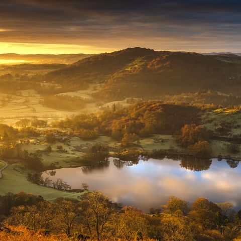 a stunning sunrise over the old loughrigg tarn at the heart of the english lake district national park, cumbria uk