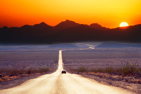 Car on road at sunset