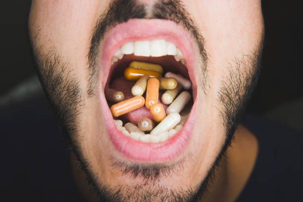 pills, pills in mouth, popping pills, vitamins, supplement pills, pill capsules, medicine, drugs