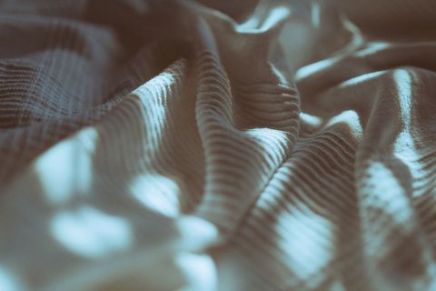 Close-Up Of Blanket On Bed