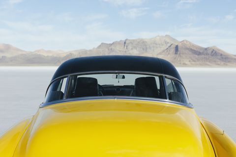 Restored yellow 1952 Vintage Chevy Bel Air car parked on Salt Flats
