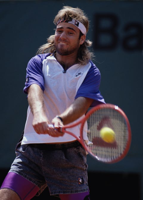 andre agassi of the united states makes a double hand return against patrick mcenroe during their mens singles third round match at the french open tennis championship on 2nd june 1991at the stade roland garros stadium in paris, france photo by bob martingetty images